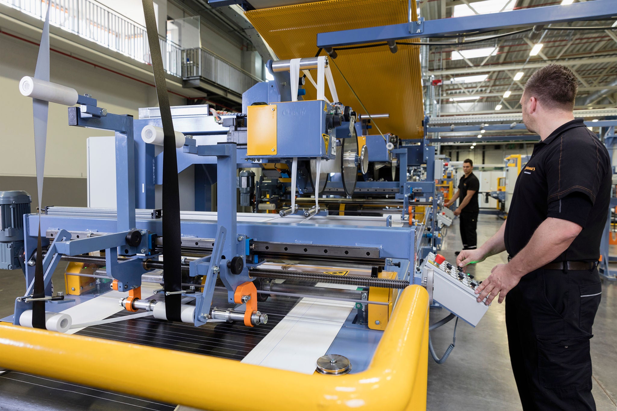 Two men working inside the High Performance Technology Center in Korbach