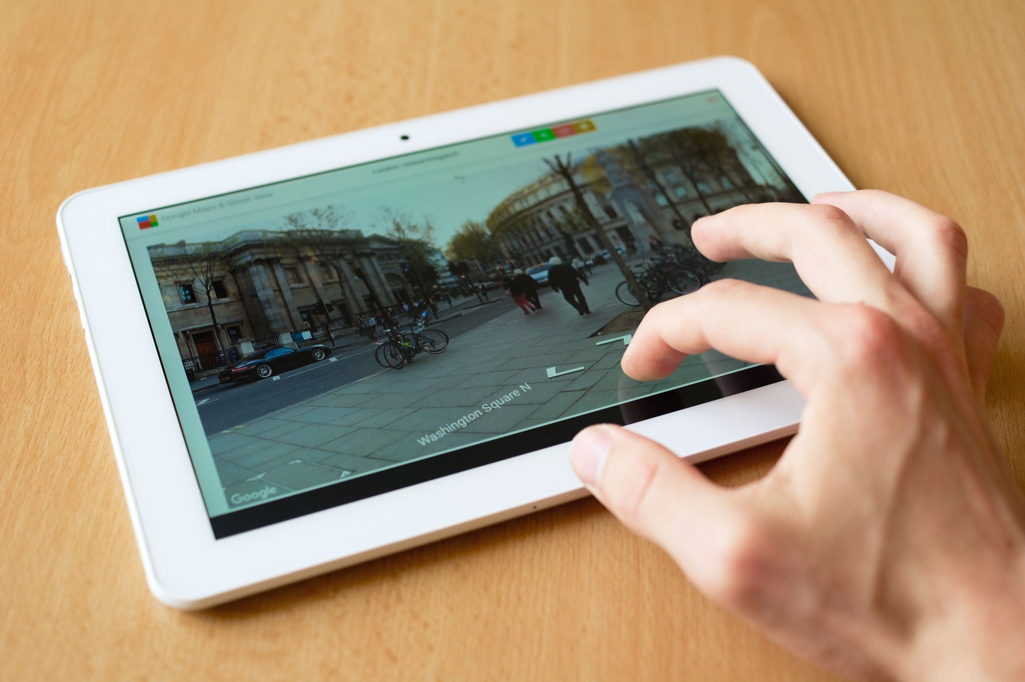 HAVIROV, CZECH REPUBLIC - APRIL 18, 2016: Man's hand use with his fingers tablet. Street View homepage is on the screen. Street view provides panoramic of many streets (shallow selective focus); Shutterstock ID 408545491; Purchase Order: -