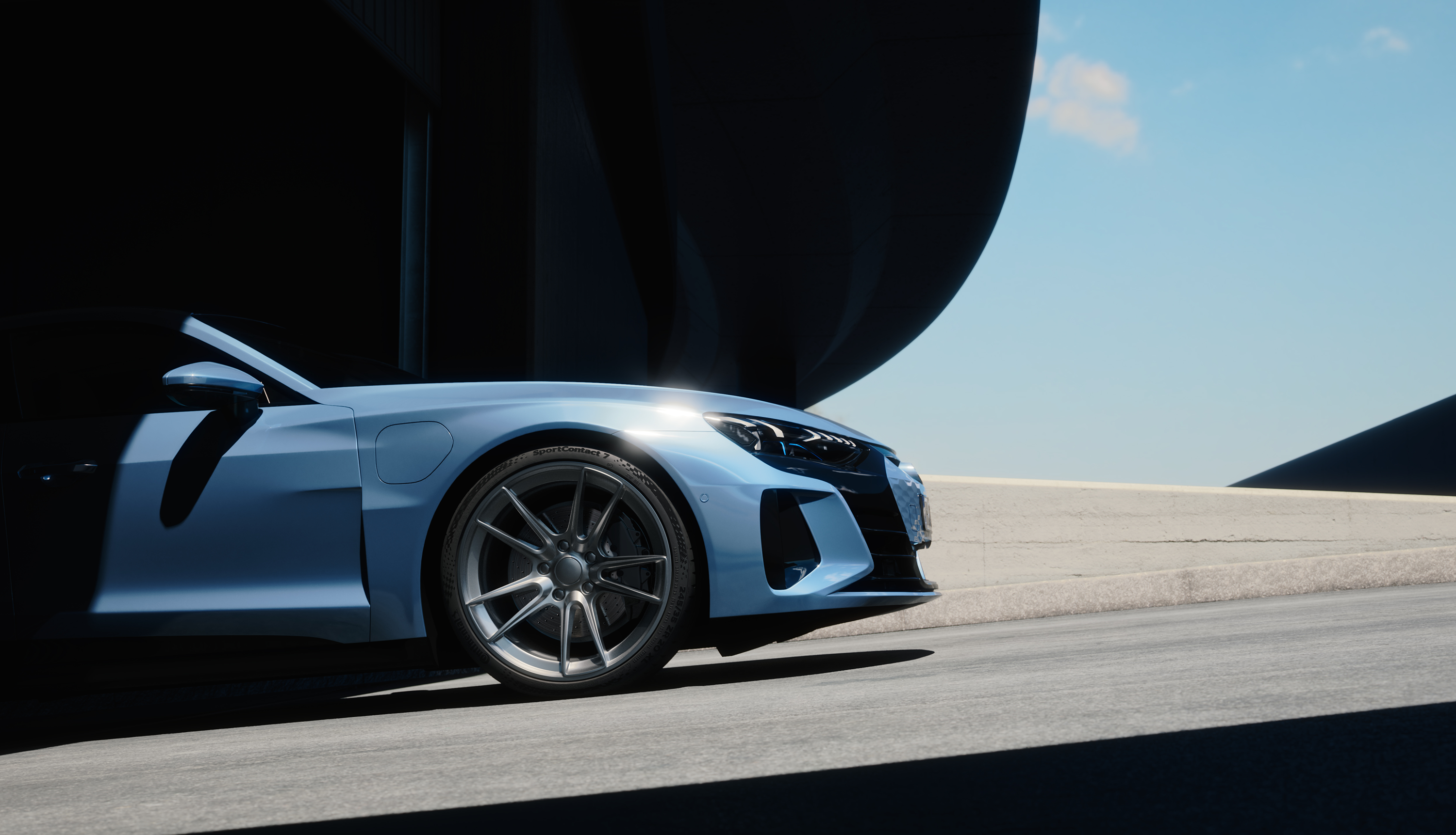 A blue sports car driving on a road