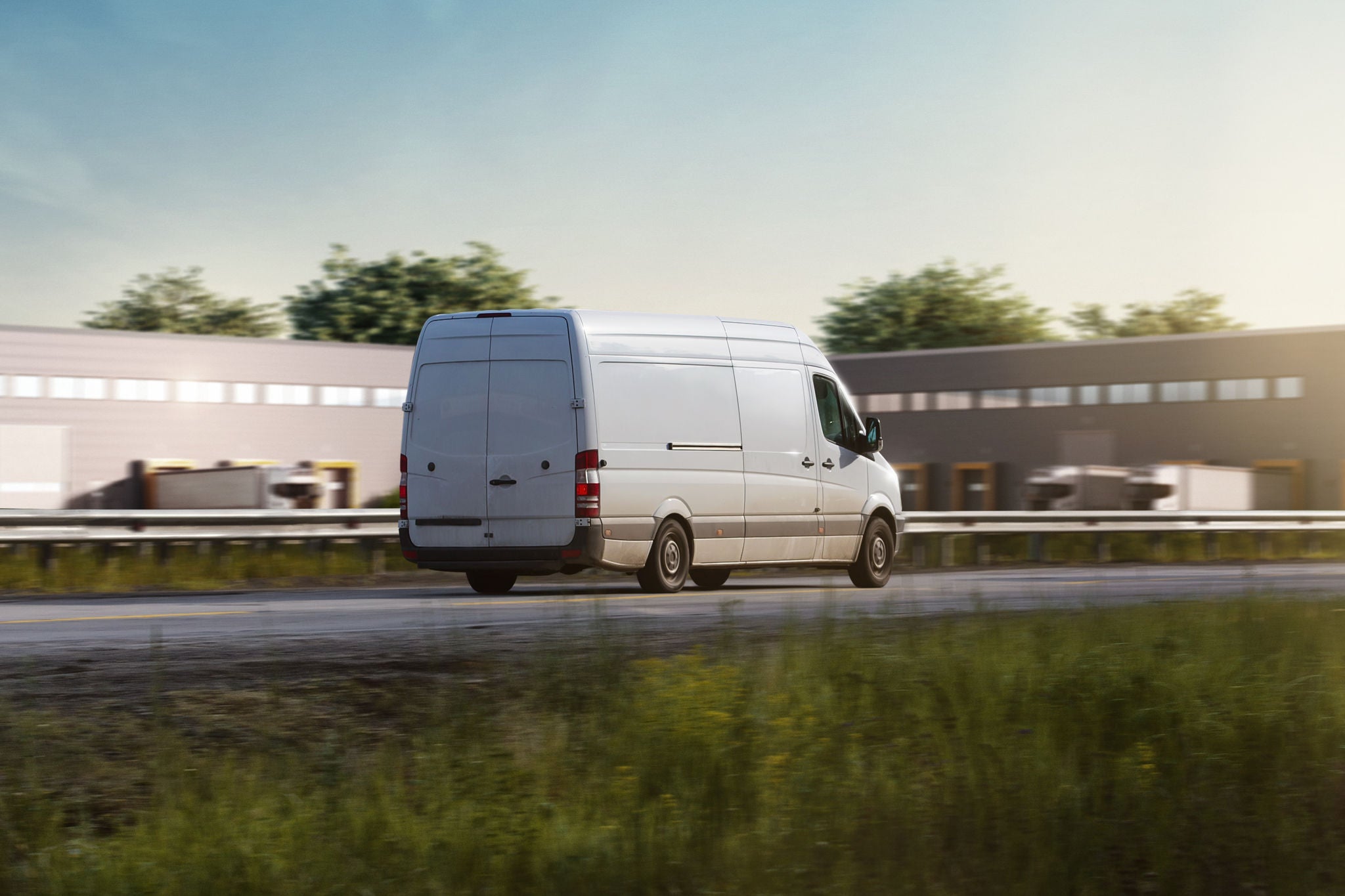 white Van driving on a Street