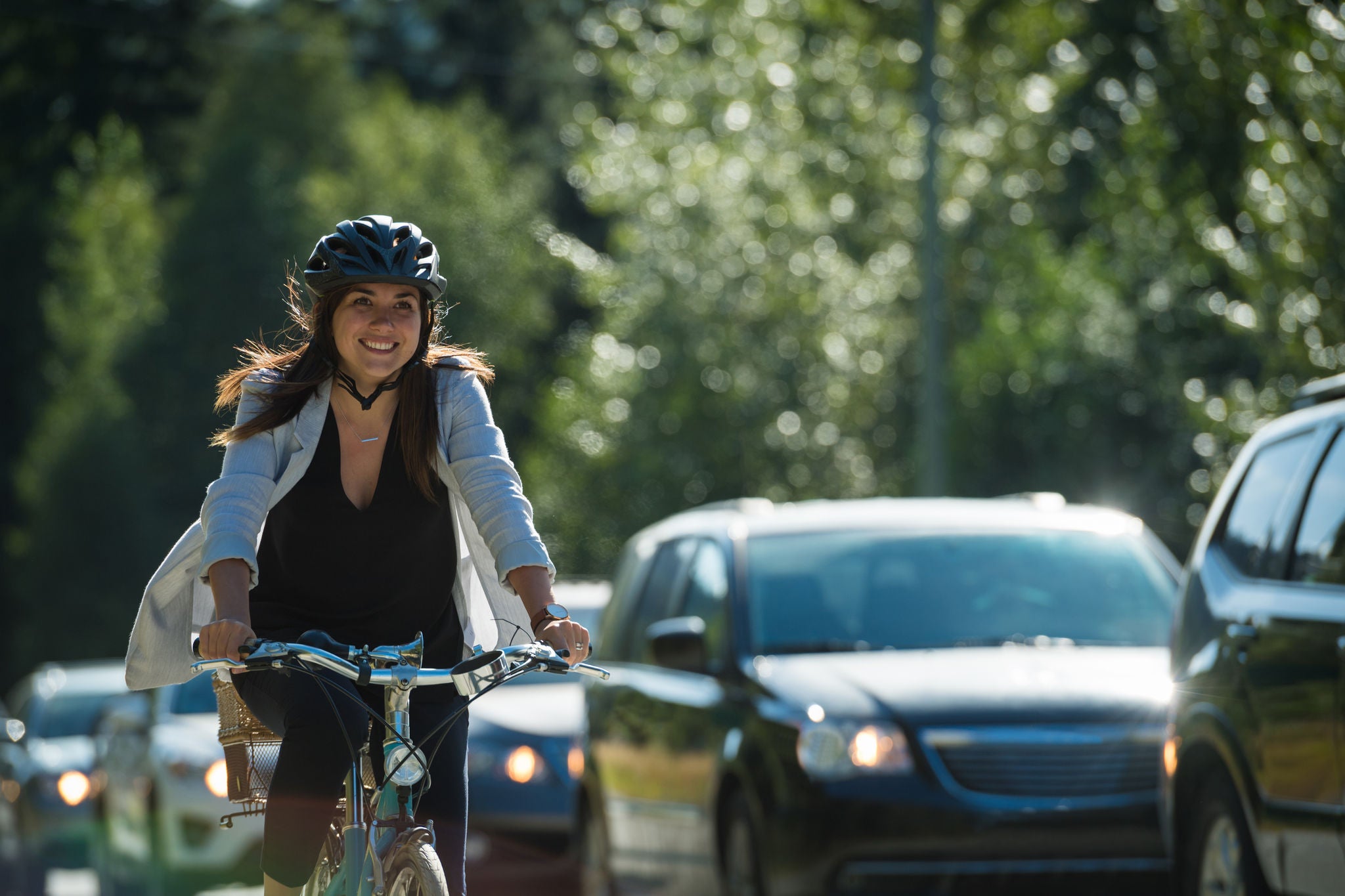 Woman passing traffic on her bike in a cycling lane