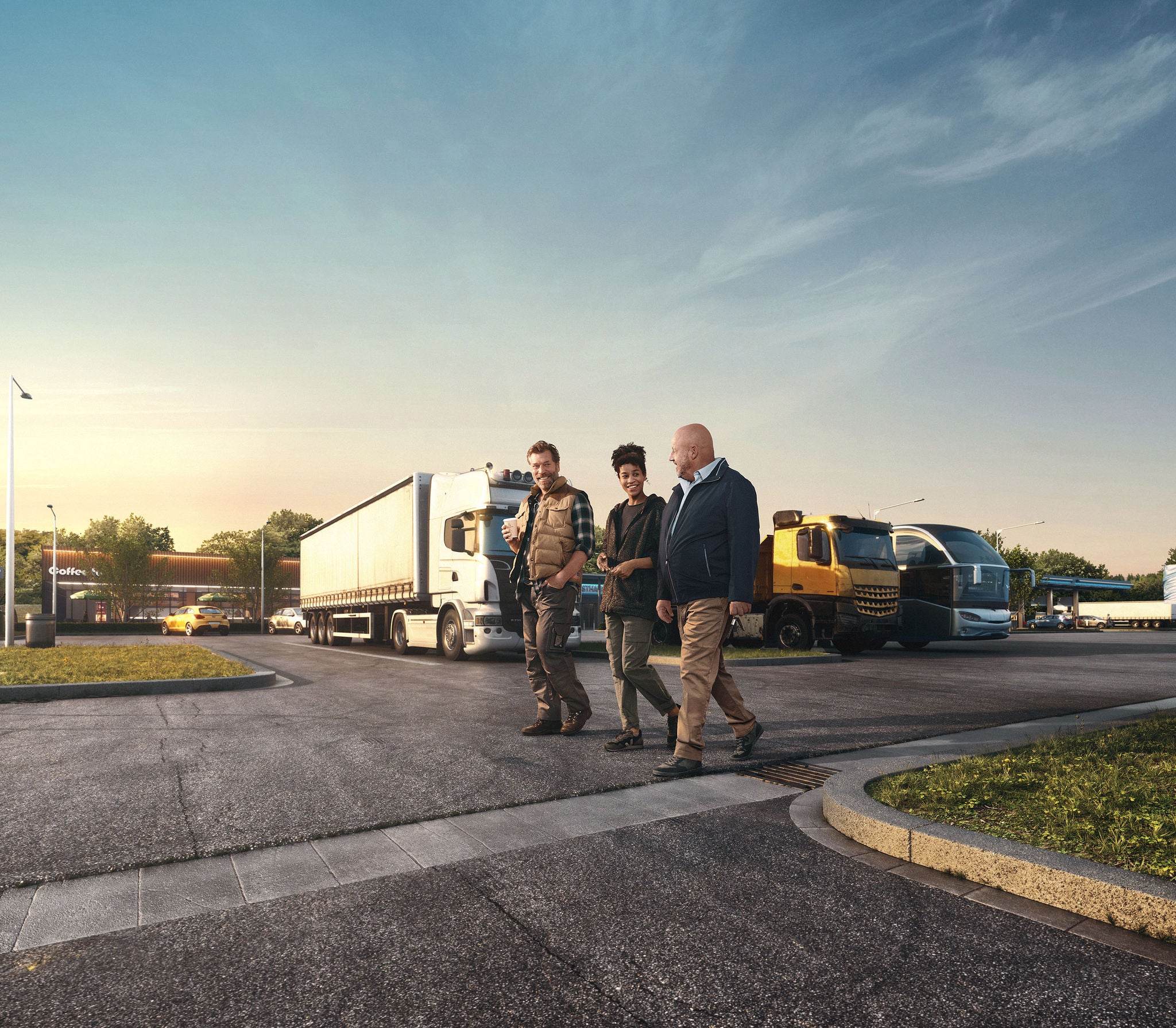 Three people walk in front of parked trucks