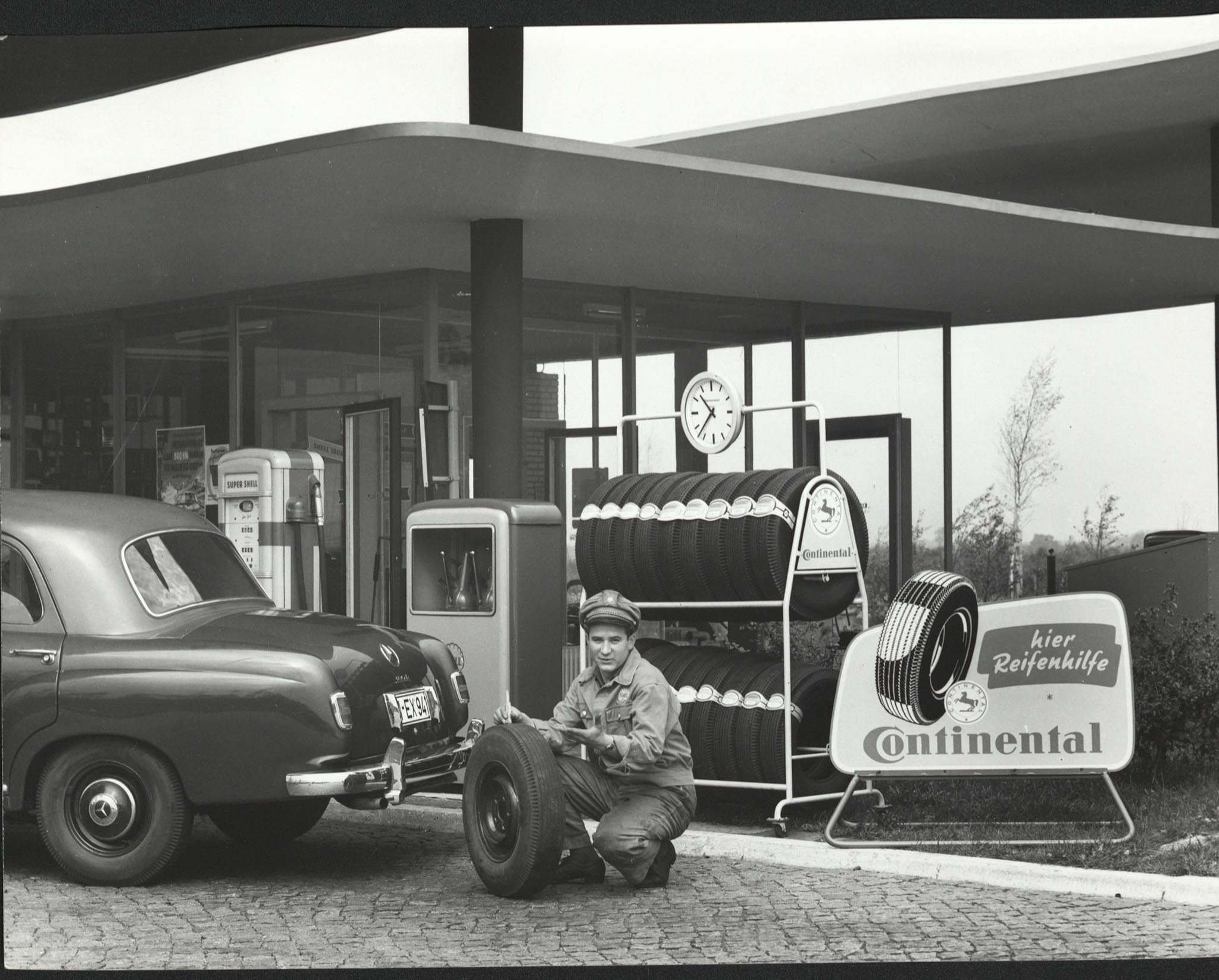 Person changing a tire, black and white image