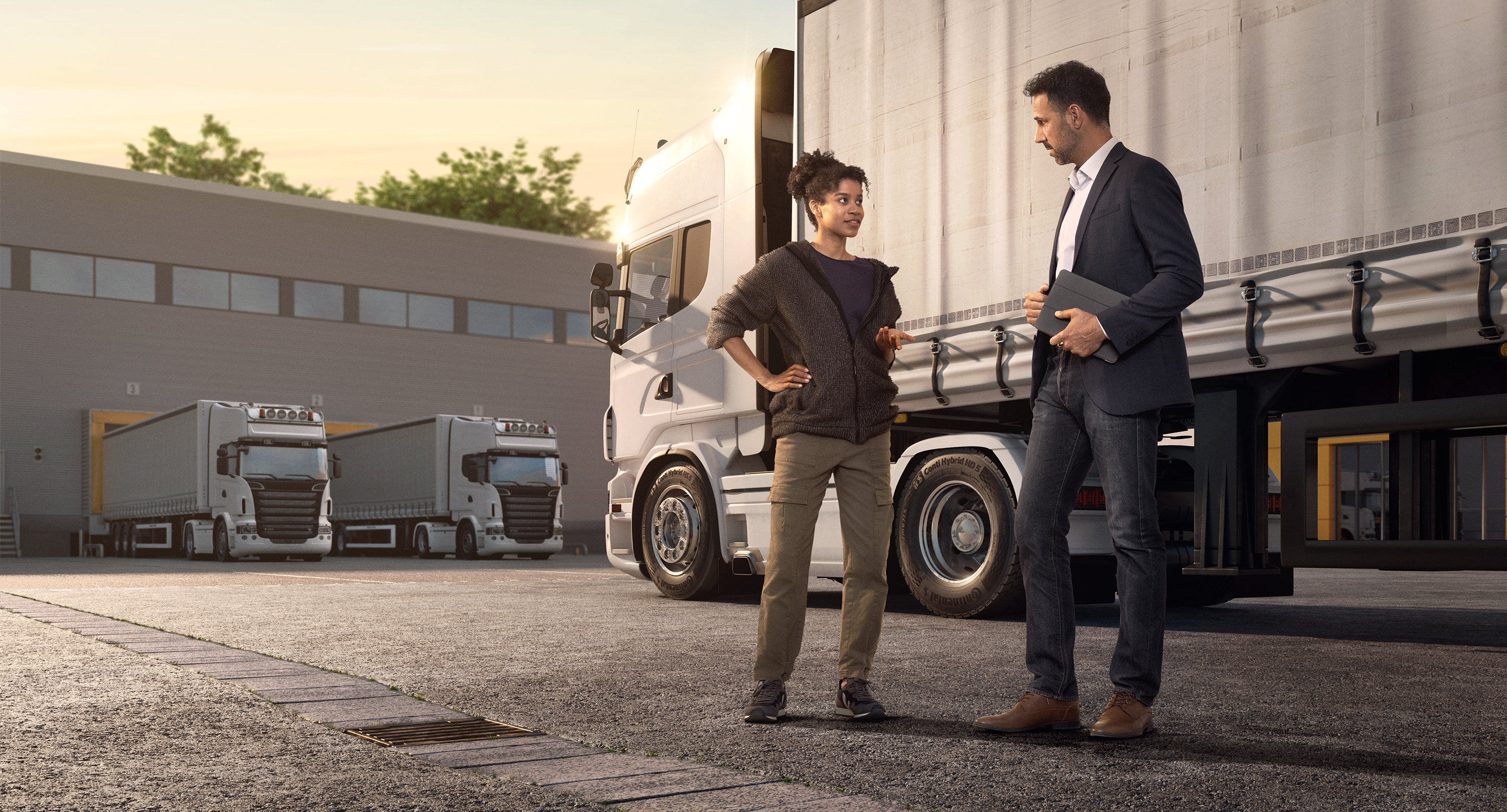 Two people talking in front of a truck